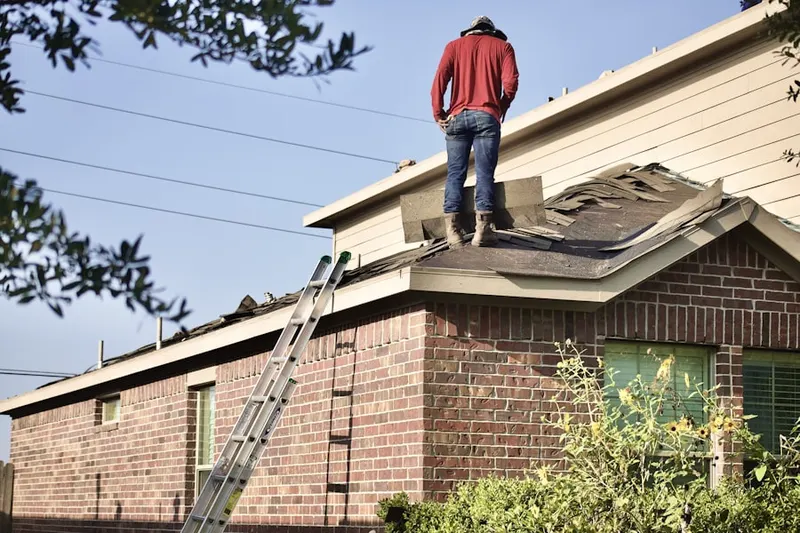 Professional roofer working on a residential roof in Green Mountain Park